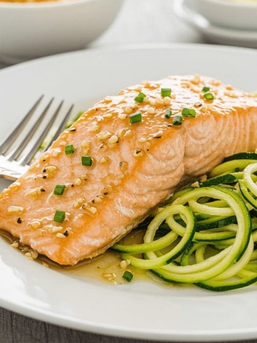 Garlic Butter Salmon with Zucchini Noodles on a white plate