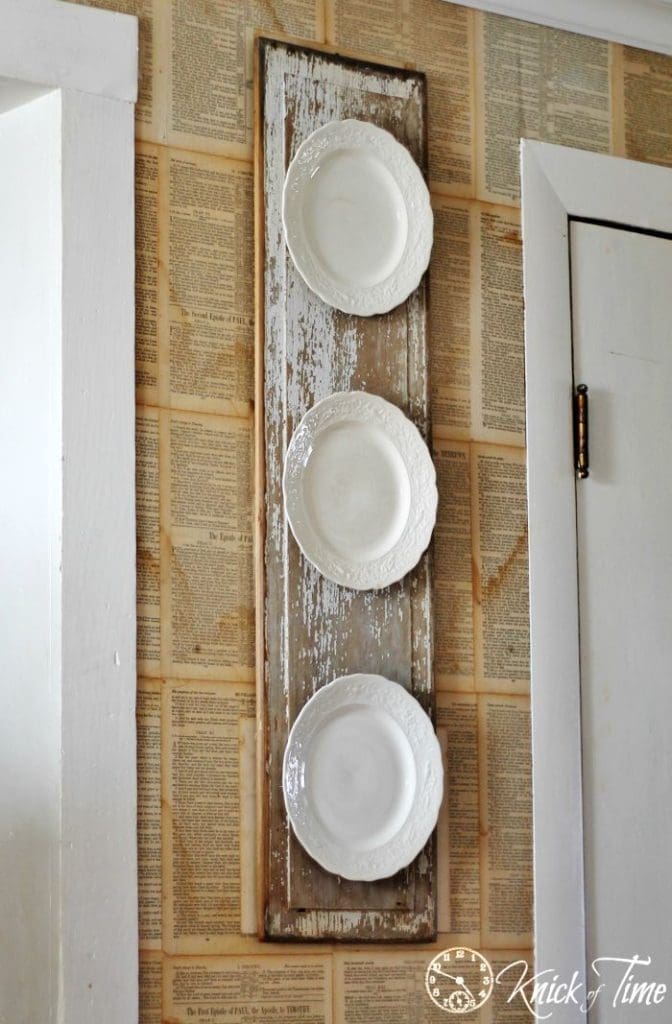 plates mounted to wooden panel