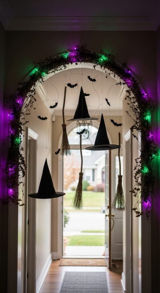 Black witches hats hanging from the ceiling in the entryway