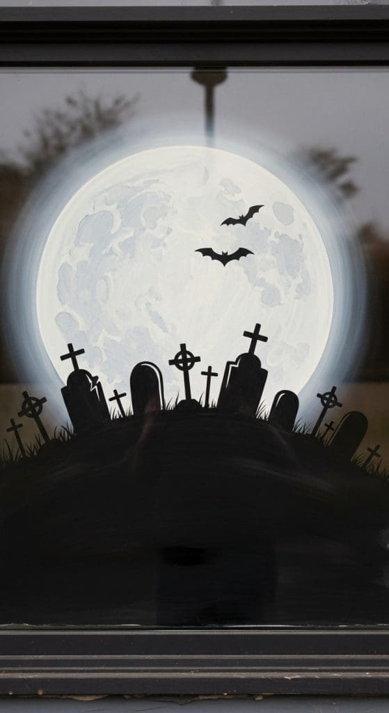 Easy DIY Halloween Window Painting of grey graveyard and moon