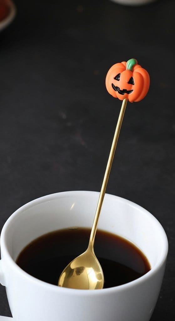 halloween themed coffee spoon in a coffee mug with a pumpkin head