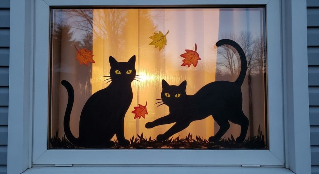 Halloween Window Painting of two black cats in a window
