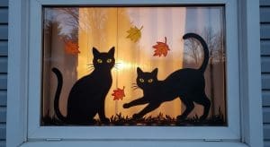 Halloween Window Painting of two black cats in a window