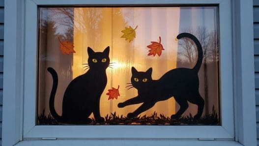 Halloween Window Painting of two black cats in a window