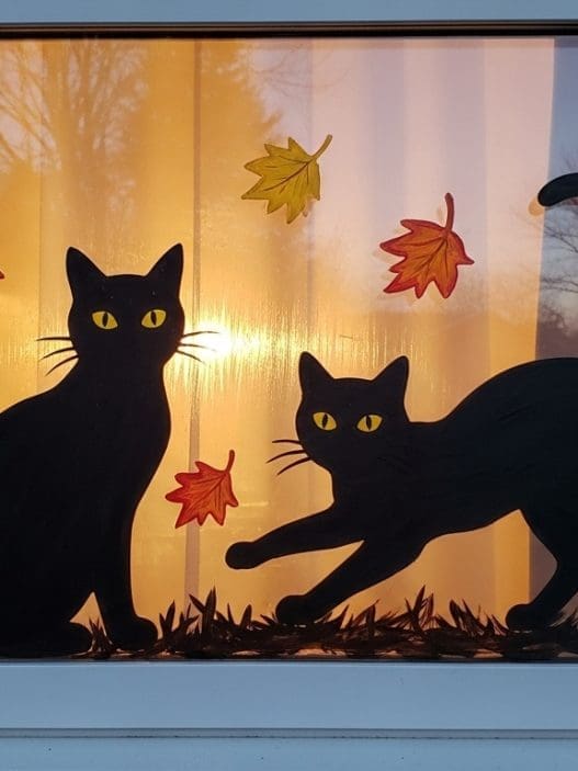 Halloween Window Painting of two black cats in a window