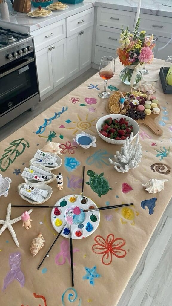 paper on table with paints and pencils as a thanksgiving entertainment idea